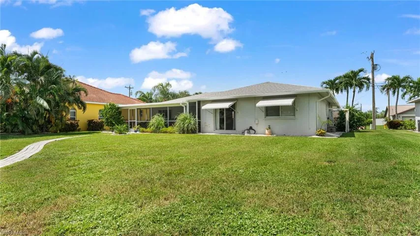 Back of house with a lawn