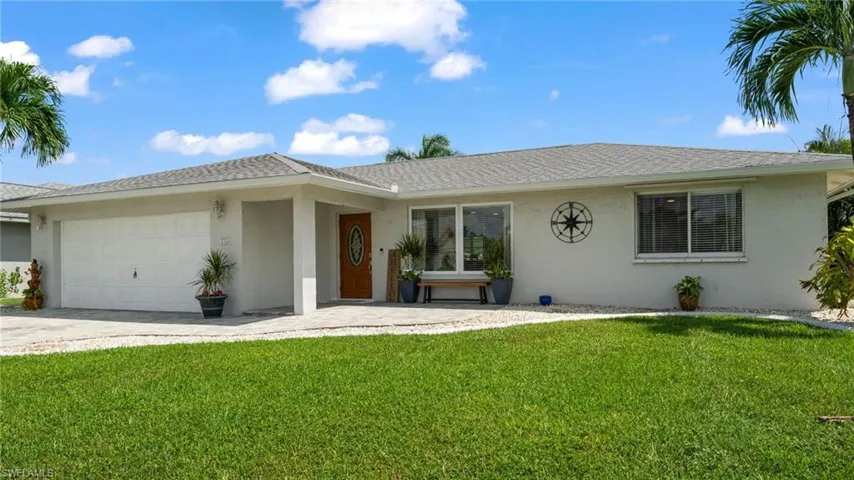 Ranch-style home featuring a garage and a front yard