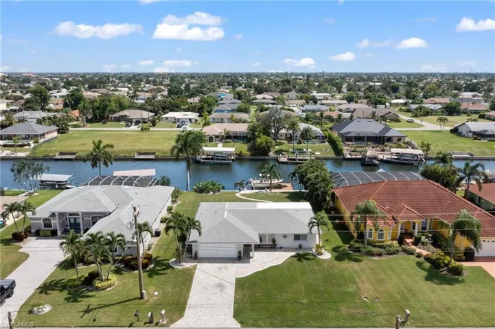 Birds eye view of property with a water view