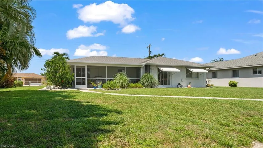 Single story home with a sunroom and a front yard