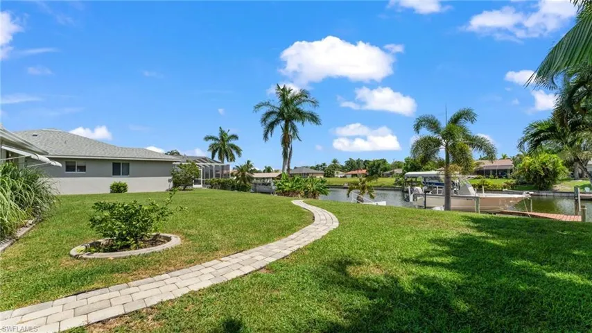 View of yard with a dock and a water view