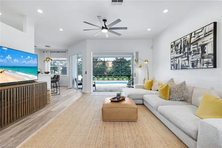 Living room featuring recessed lighting, ceiling fan, and plenty of natural light