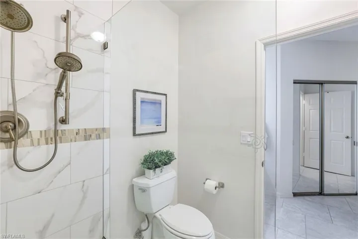 Primary with mirrored sliders to closet