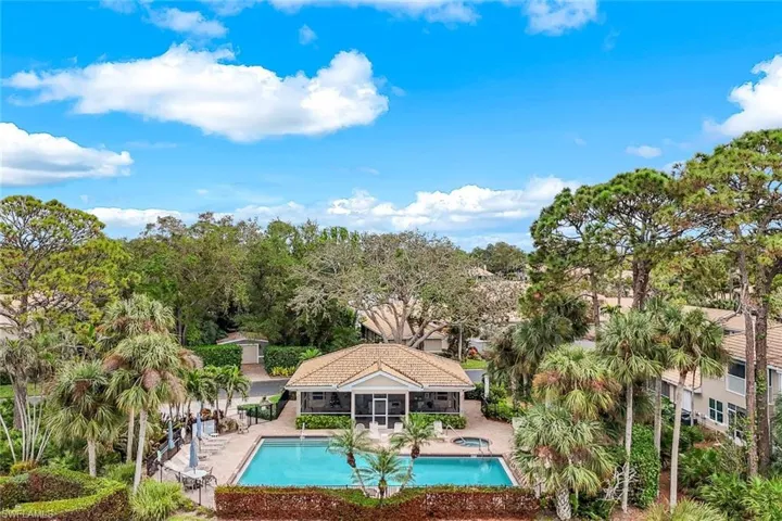 View of swimming pool with a patio area and a sunroom