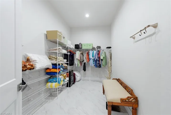White walls, recessed lighting, and white tile flooring