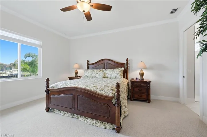 Recessed lighting, ceiling fan, crown molding, double window, and light-toned carpet