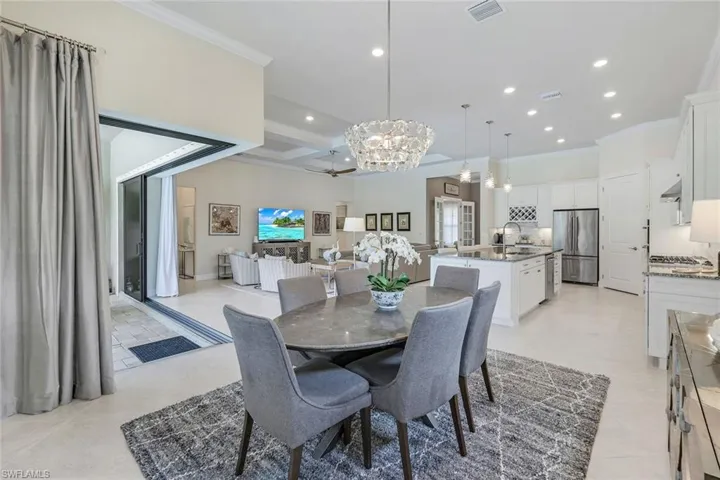 Dining area has designer crystal light, open to both family rm and kitchen