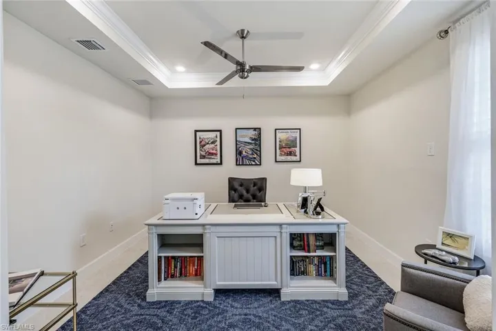 Home office with crown molding, tray ceiling, ceiling fan, high speed internet