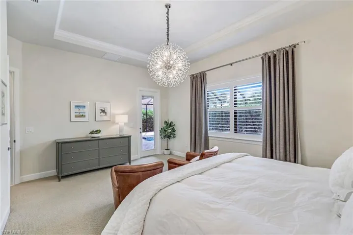 Primary bedroom features direct access to exterior lanai for easy rinse off