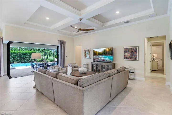 Great room featuring coffered ceiling, extensive recess lighting, coffered ceiling, crown molding