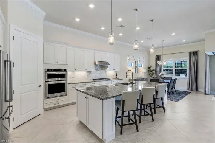 Open concept to dining room, great room, and pool lanai.