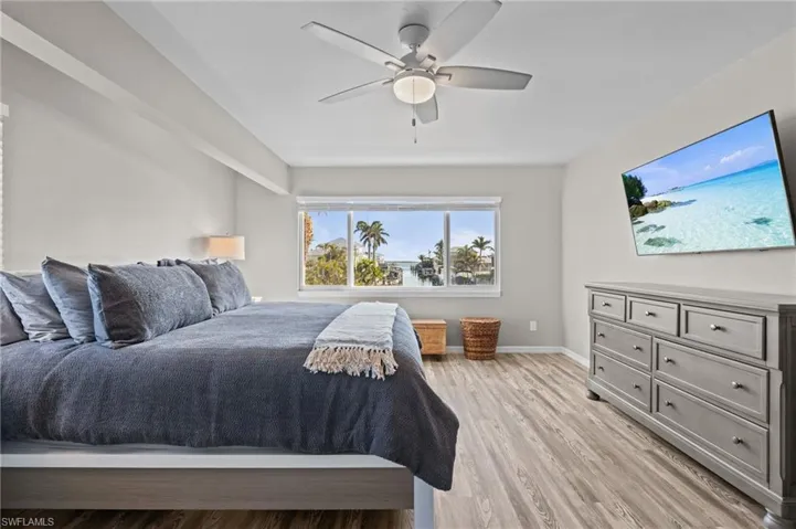 Bedroom with light wood-type flooring and a ceiling fan