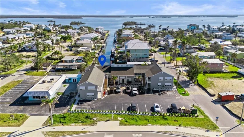 Aerial view of residential area featuring a nearby body of water