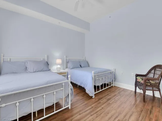 Bedroom with baseboards, ceiling fan, and wood finished floors