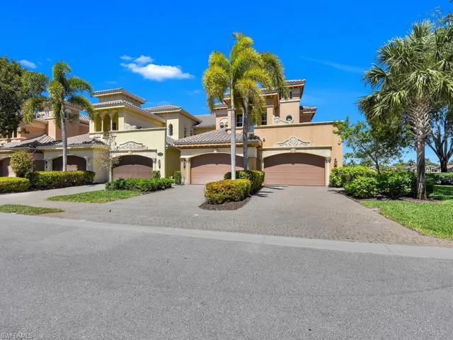 Mediterranean / spanish house featuring driveway, stucco siding, a tile roof, and an attached garage