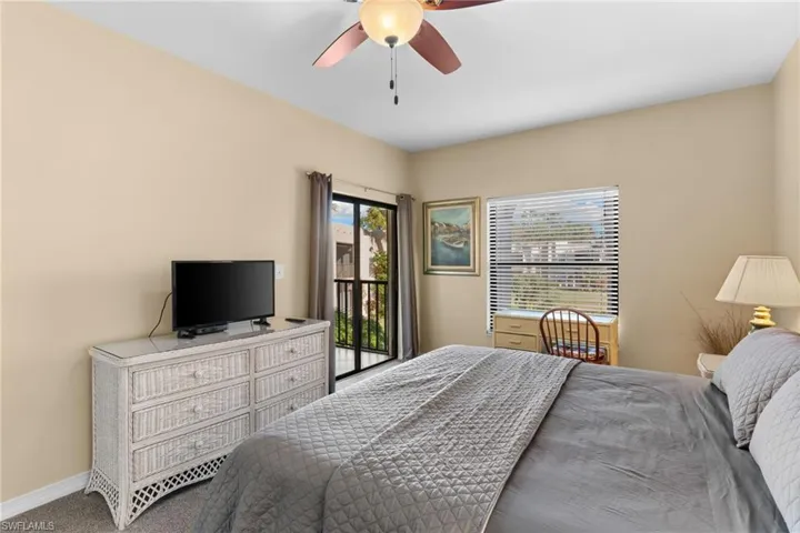 Spacious primary suite offers private lanai access, an en-suite bathroom, and generous closet space.
