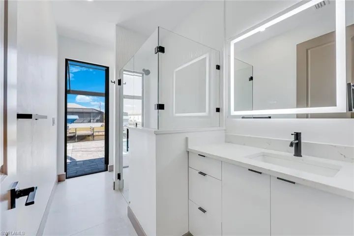 Bathroom 3 with door to the pool, beautiful tiled shower and smart mirror