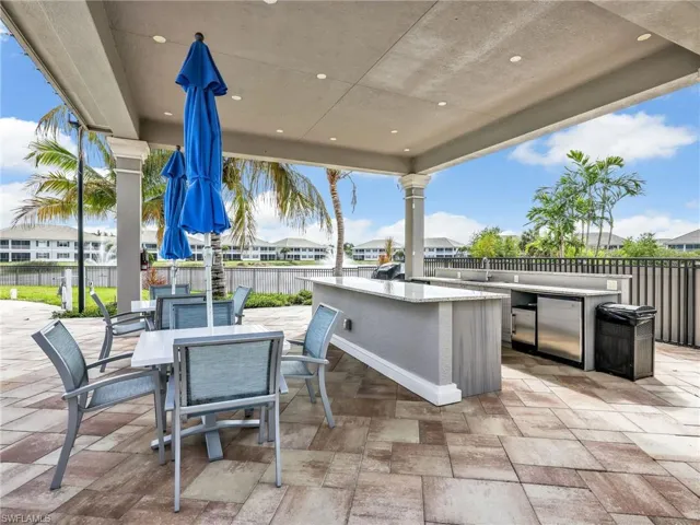 View of patio featuring a residential view, area for grilling, and an outdoor bar and dining area