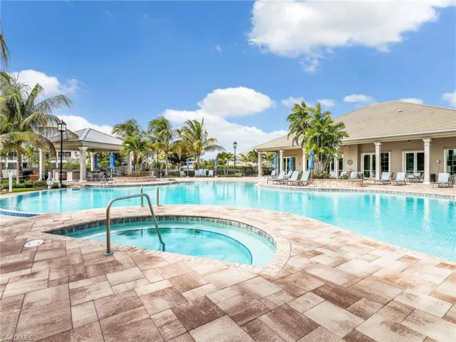 Community pool featuring a patio area and a hot tub