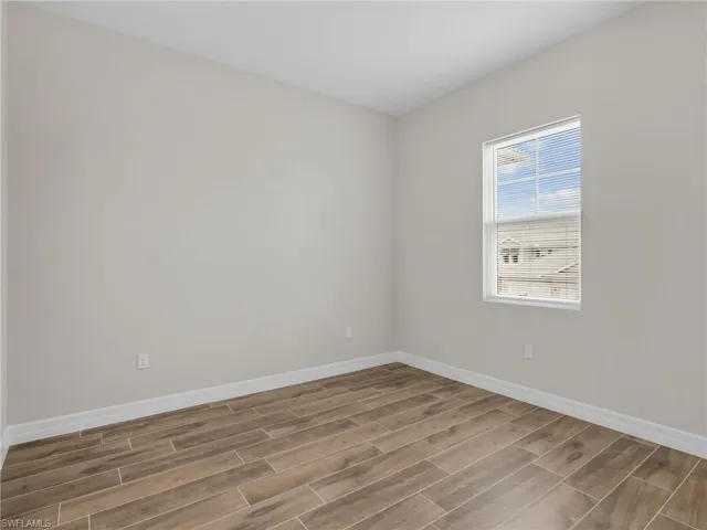 Spare room with wood finish floors