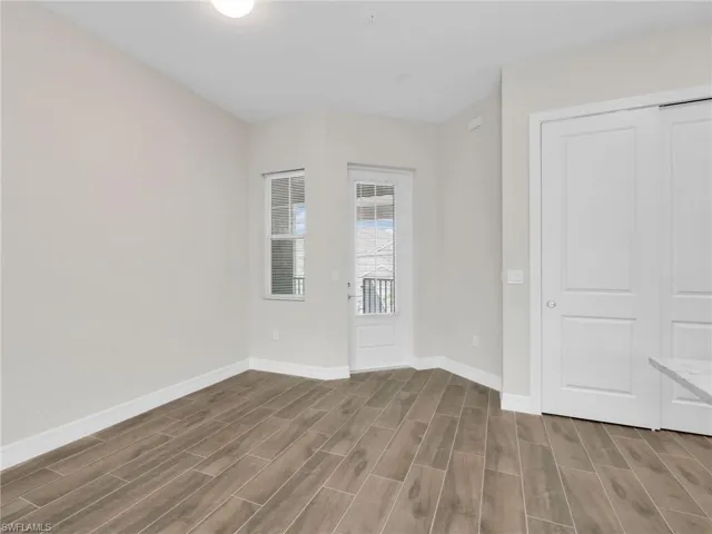 Unfurnished bedroom with wood tiled floors and a closet