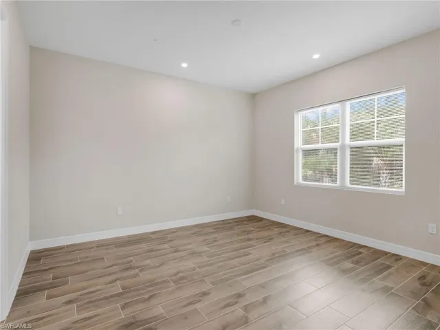 Empty room featuring wood tiled floors and recessed lighting