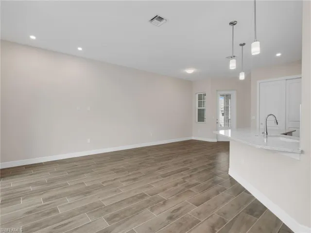 Unfurnished living room with recessed lighting and wood tiled floors
