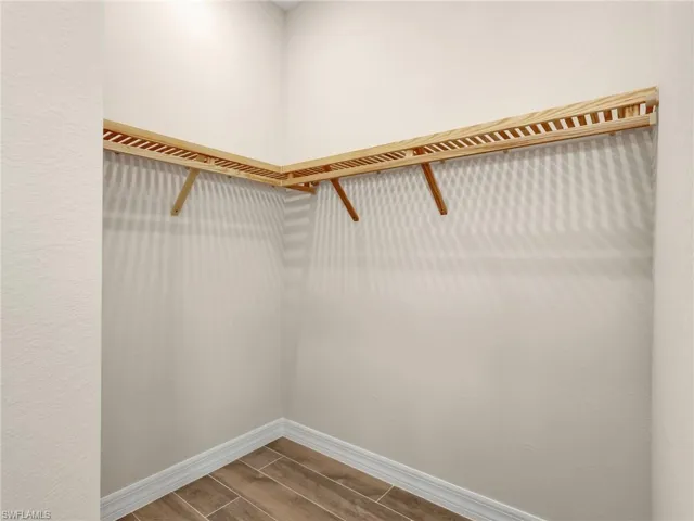 Walk in closet featuring wood tiled floors