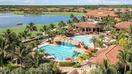 Aerial view of a pool and a nearby body of water
