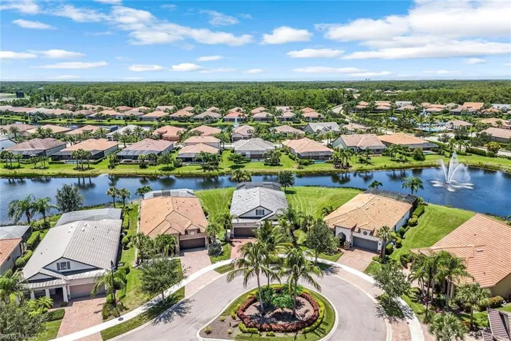 Aerial view of residential area featuring a nearby body of water