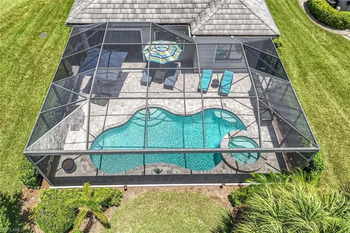 View of subject property with a pool area
