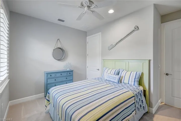 Bedroom featuring carpet, ceiling fan, and recessed lighting