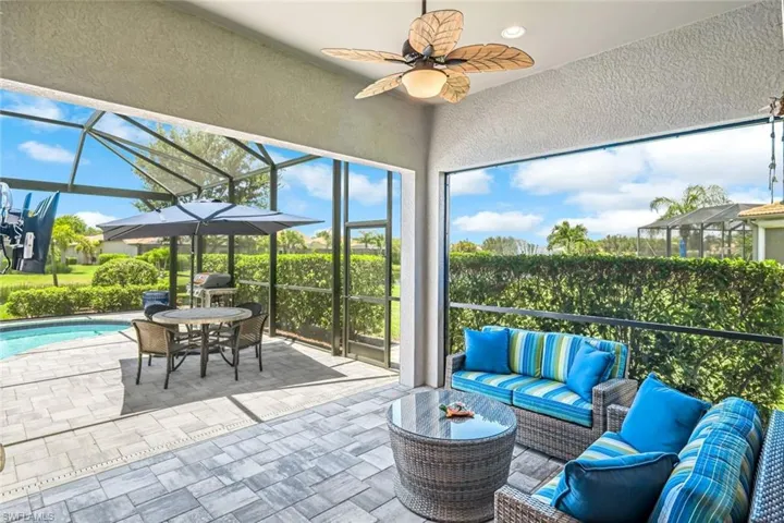 View of patio / terrace featuring an outdoor living space, a lanai, an outdoor pool, and a ceiling fan