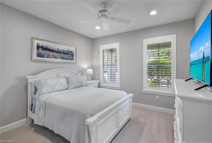 Bedroom with recessed lighting, light carpet, and a ceiling fan