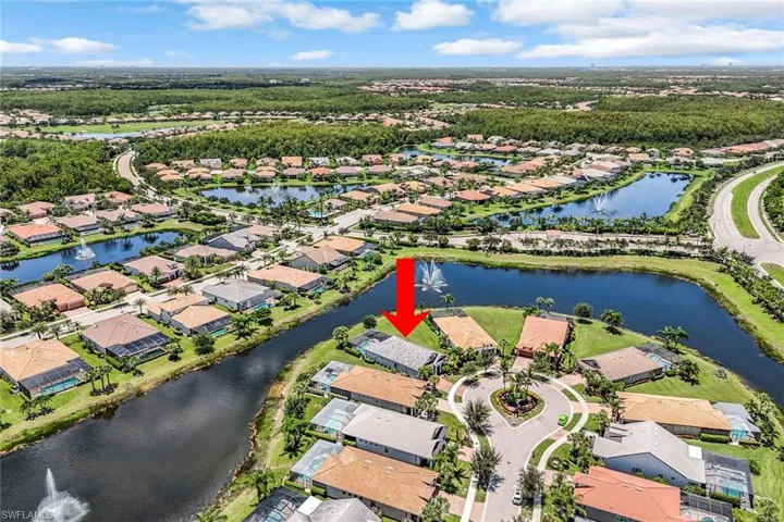Aerial view of property's location with nearby suburban area and a nearby body of water