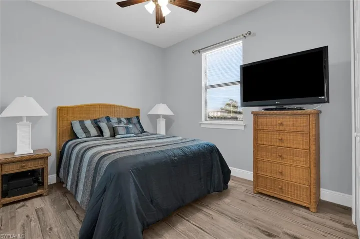 Bedroom with a ceiling fan and light wood-style floors