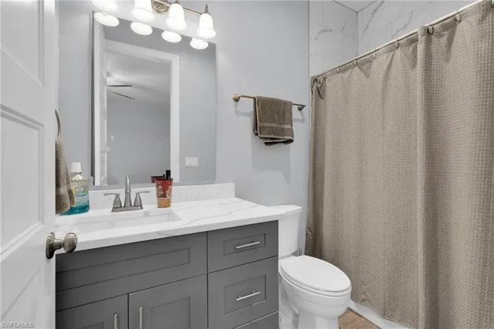 Full bath featuring a shower with curtain and vanity