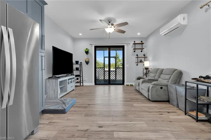 Living area featuring ceiling fan, light wood-style floors, and recessed lighting