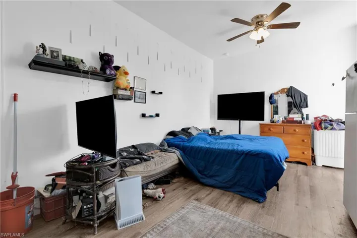 Bedroom with wood finished floors and a ceiling fan