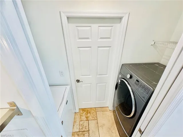 Washroom with washing machine and clothes dryer