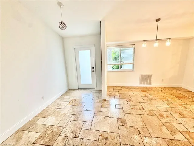 Entryway featuring stone tile flooring and baseboards