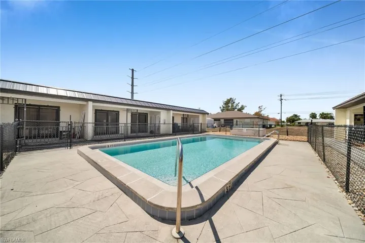Community pool featuring a patio