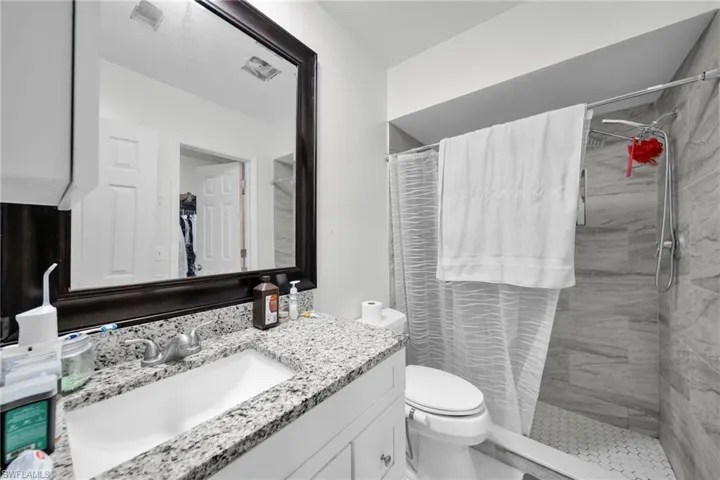 Full bath with vanity and a shower stall