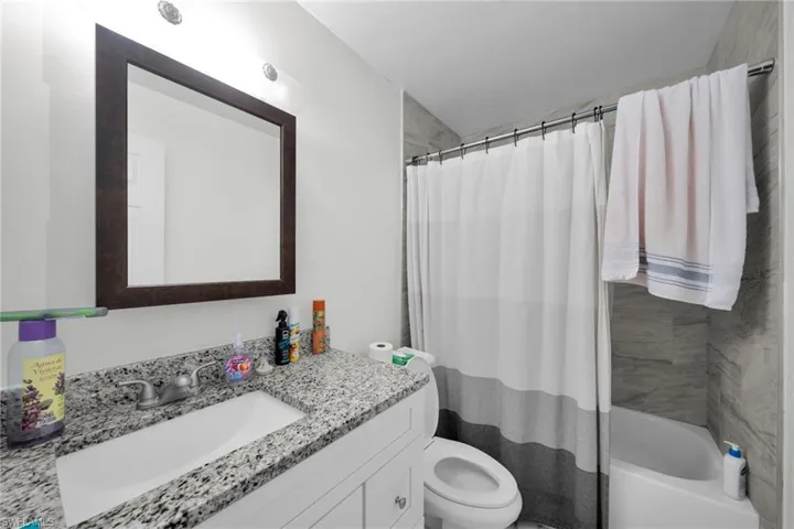 Full bathroom featuring vanity and shower / bathtub combination with curtain