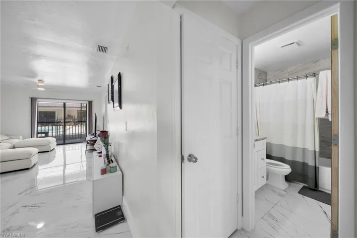 Hallway with light marble finish floors