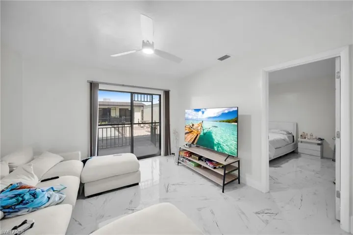 Living area with light marble finish flooring and ceiling fan