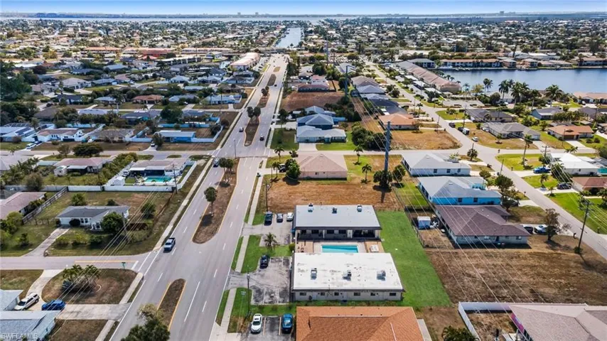 View of property location with nearby suburban area and a nearby body of water