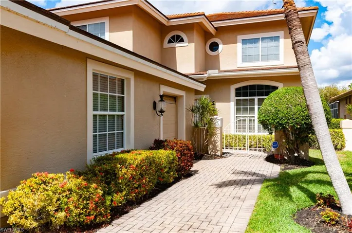 Doorway to property featuring stucco siding