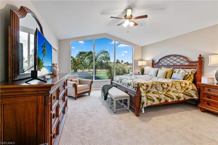Bedroom featuring light carpet and ceiling fan