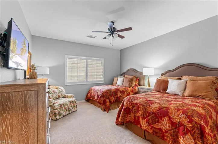 Bedroom featuring light colored carpet and ceiling fan